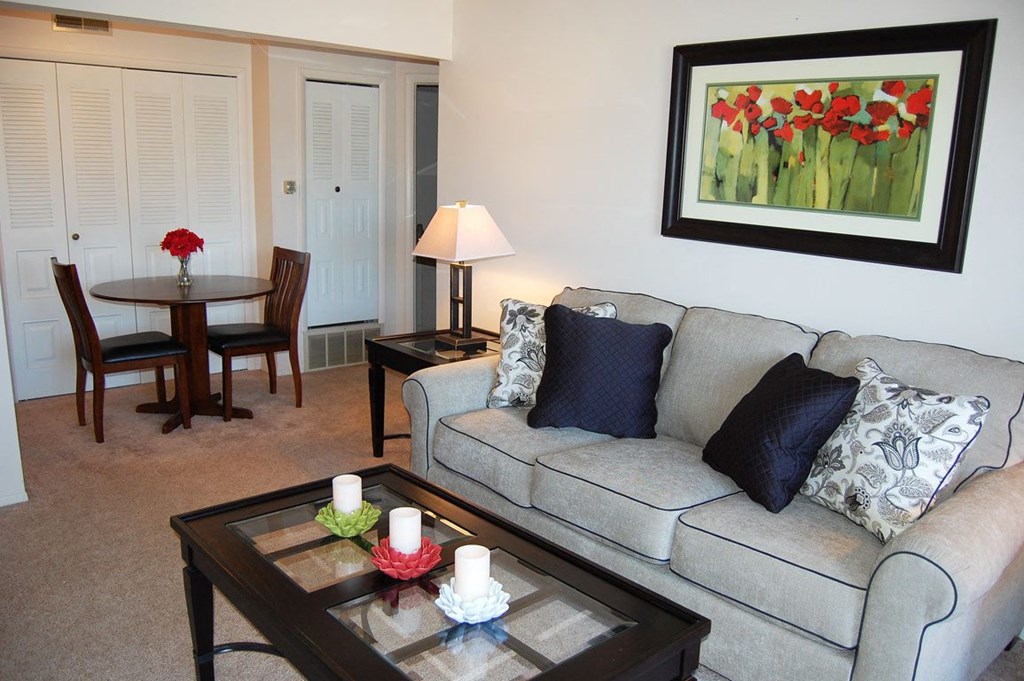 Bright Living Room Leads To Dining Area with Closet at Normandy Village Apartments, Michigan City, IN