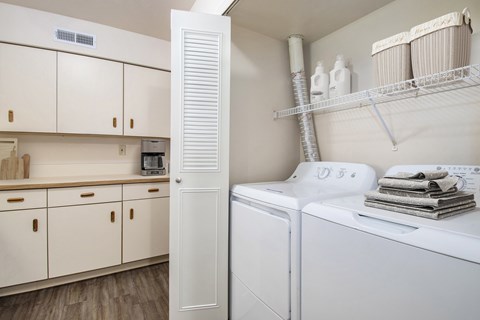 A laundry room with a washer and dryer stacked on top of each other.