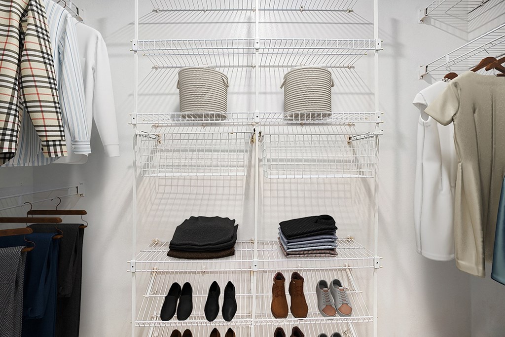 A walk-in closet with clothes and shoes organized on shelves at North Pointe Apartments, Indiana, 46514