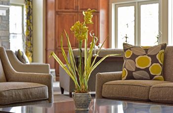 a living room filled with furniture and a large window  at Northport Apartments, Macomb, MI, 48044