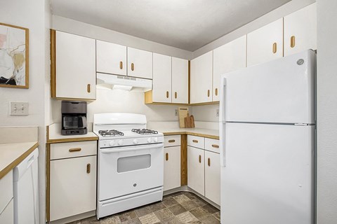 A kitchen with white appliances at Oak Shores Apartments in Oak Creek, WI