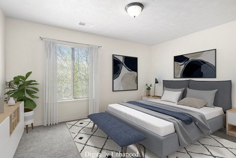 A bedroom with a large bed and a window with curtains at Old Farm Apartments, Elkhart, Indiana