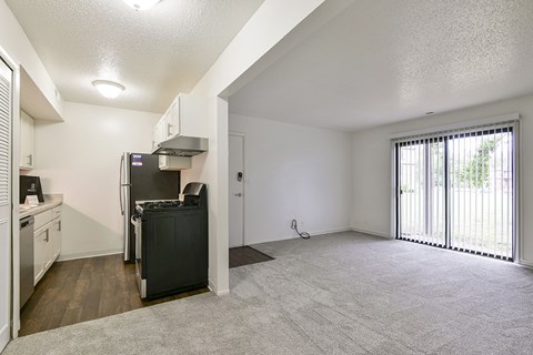 A kitchen area and a living room leading to a patio at Old Monterey Apartments, Missouri, 65807