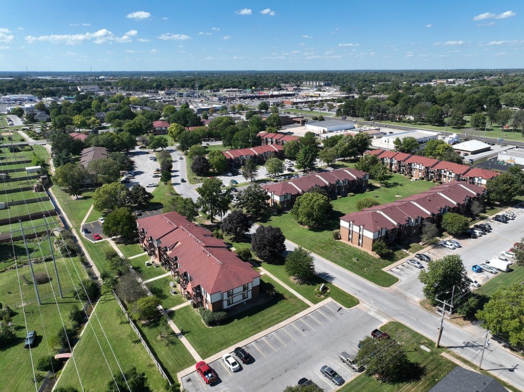 A bird's eye view of a park-like apartment community with a blue sky at Old Monterey Apartments, Springfield, MO