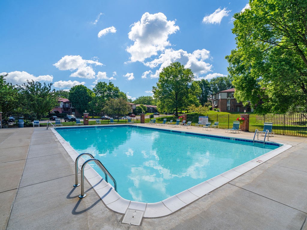 Relaxing Swimming Pool With Lounge Chairs at Old Farm Apartments, Elkhart