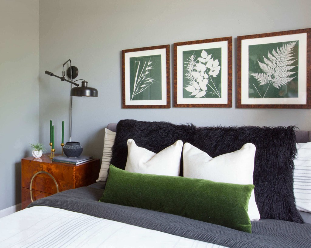 a bedroom with a bed and three pictures on the wall  at Enclave Apartments, Midlothian