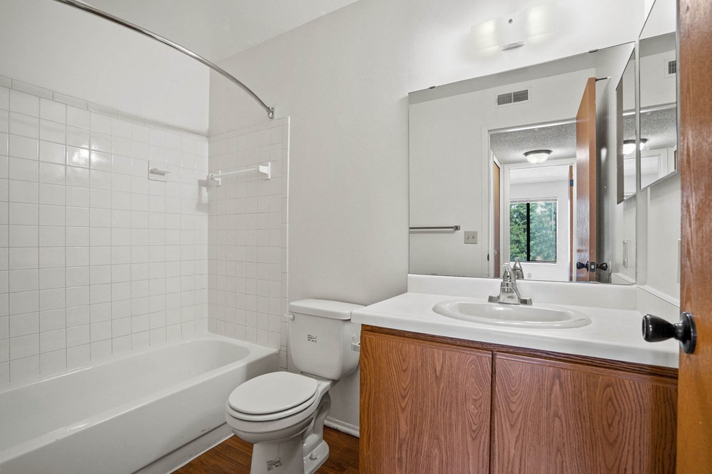 a bathroom with a toilet sink and bathtub at Beacon Hill and Great Oaks Apartments, Illinois, 61109