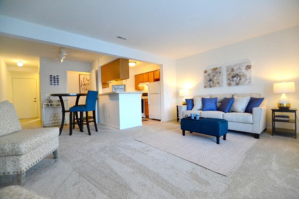 a living room with a couch and a chair at Northport Apartments, Michigan, 48044