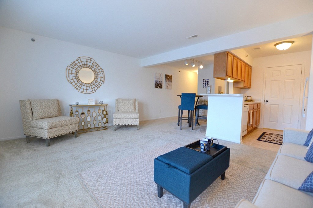 a living room with a couch a chair and a table at Northport Apartments, Macomb, Michigan