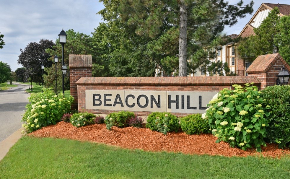 a sign that reads beacon hill in front of a building at Beacon Hill and Great Oaks Apartments, Rockford