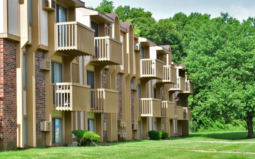a row of apartment buildings with balconies and trees in the background at Beacon Hill and Great Oaks Apartments, Rockford, IL