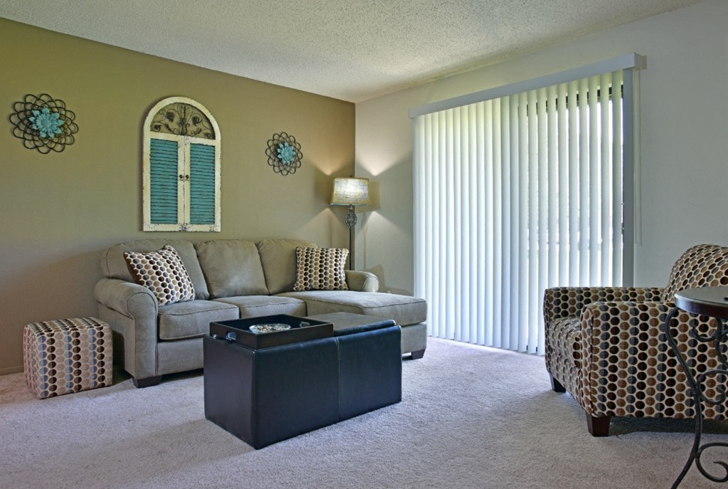 a living room with a couch chairs and a coffee table at Beacon Hill and Great Oaks Apartments, Rockford, Illinois