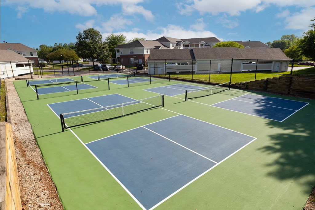 a tennis court at the enclave at woodbridge apartments in sugar land, tx at Latitudes Apartments, Indianapolis, IN