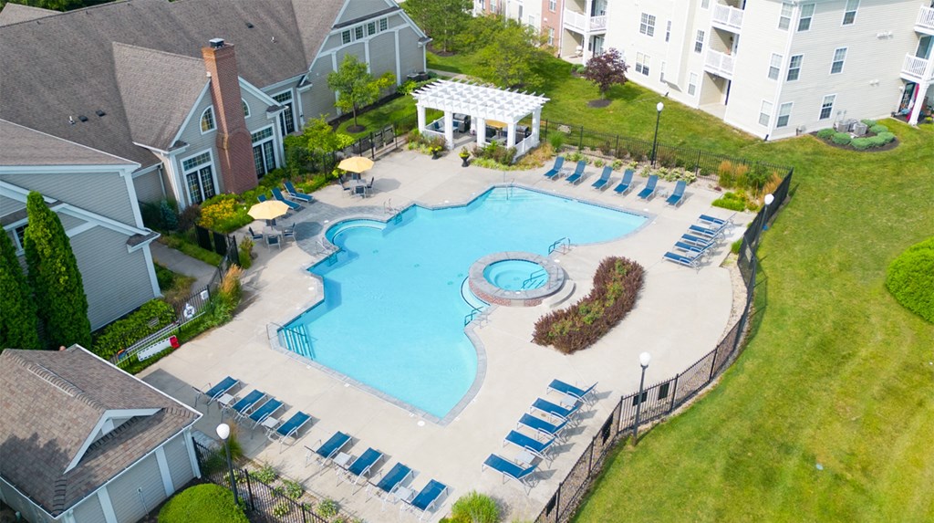 an aerial view of a resort style pool with lounge chairs and a gazebo at Latitudes Apartments, Indianapolis