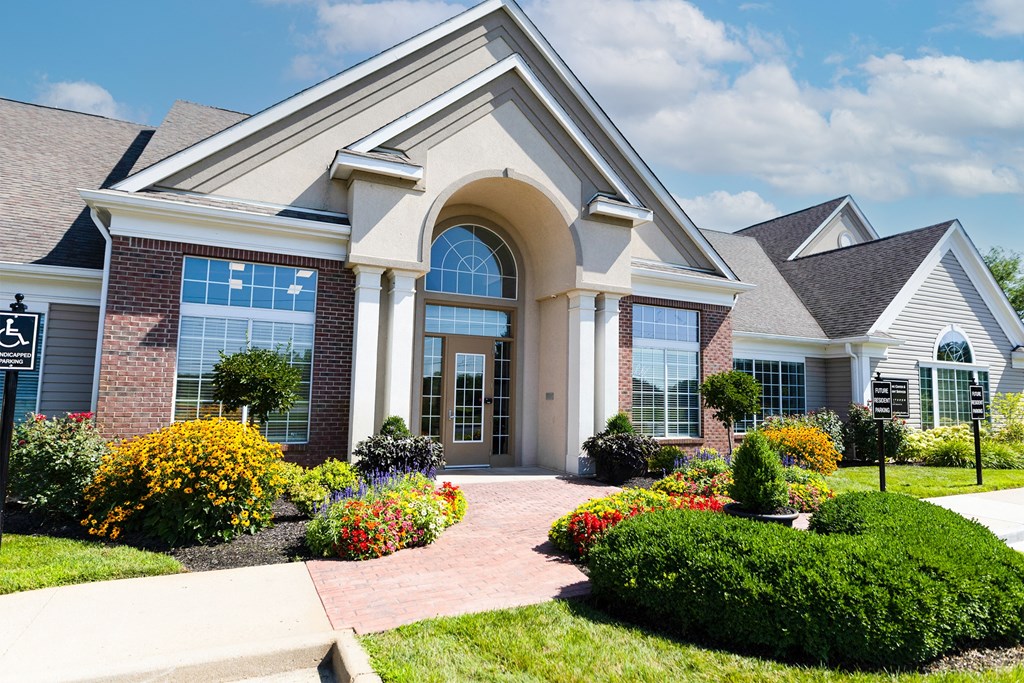 a house with a walkway and flowers in front of it at Latitudes Apartments, Indianapolis, Indiana