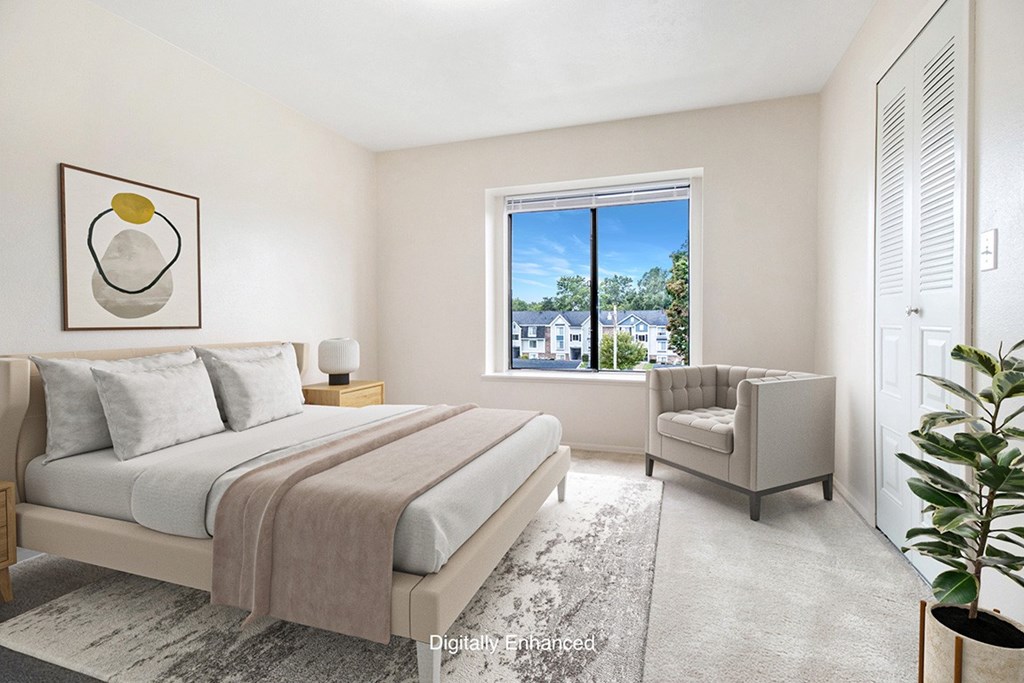 A bedroom with a large bed and a window and walk in closet A bedroom with a large bed and a window and walk in closet at Pine Knoll Apartments, Battle Creek