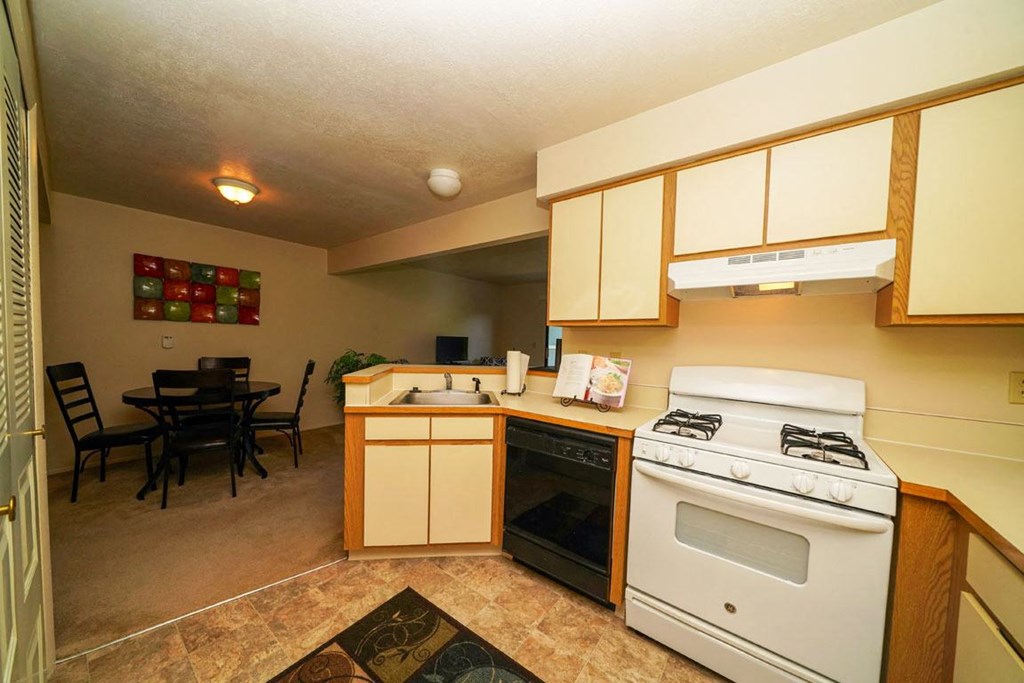 Kitchen with Breakfast Bar at Pine Knoll Apartments, Battle Creek, MI