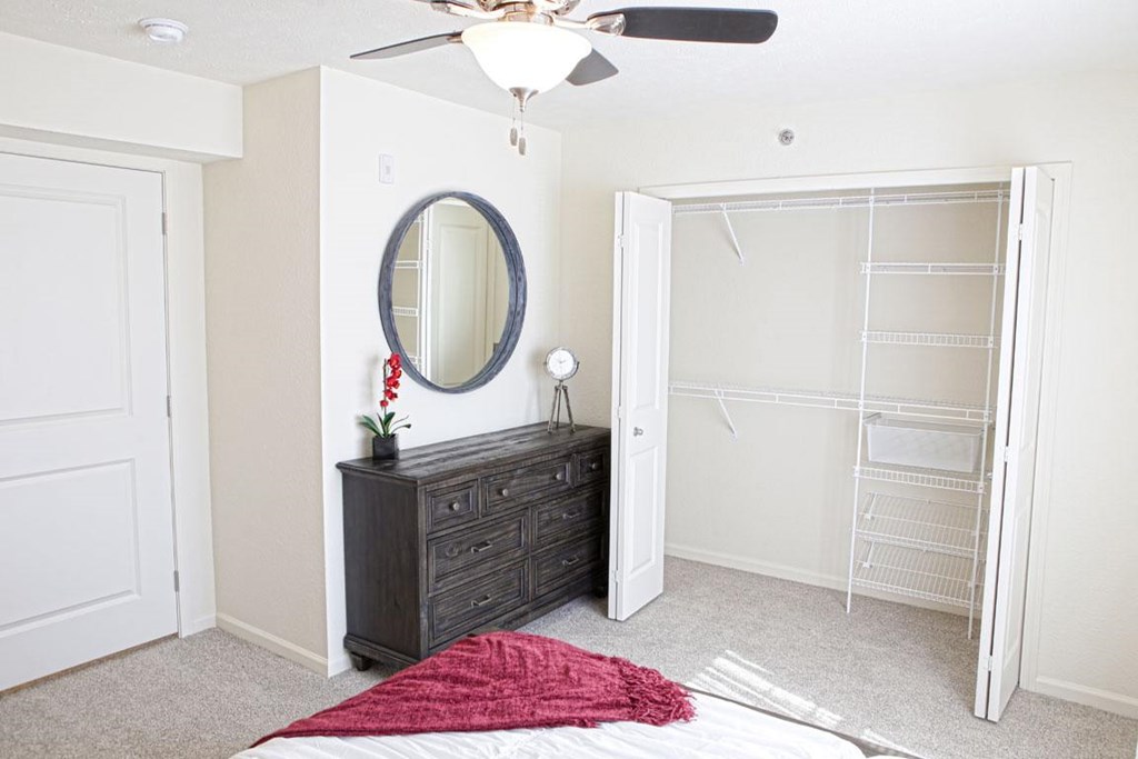 A bedroom with a walk-in closet at The Reserve at Destination Pointe, Grimes