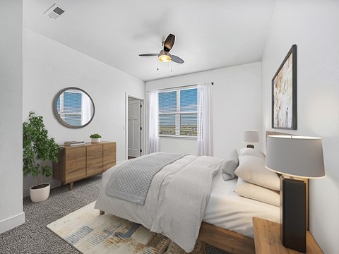 A bedroom with a bed, a ceiling fan, walk-in closet and a window with blinds at The Reserve at Destination Pointe apartments, Grimes, IA