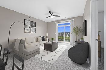 A living room with a 9' ceiling, grey sofa, armchair, and coffee table at The Reserve at Destination Pointe apartments, Grimes, IA