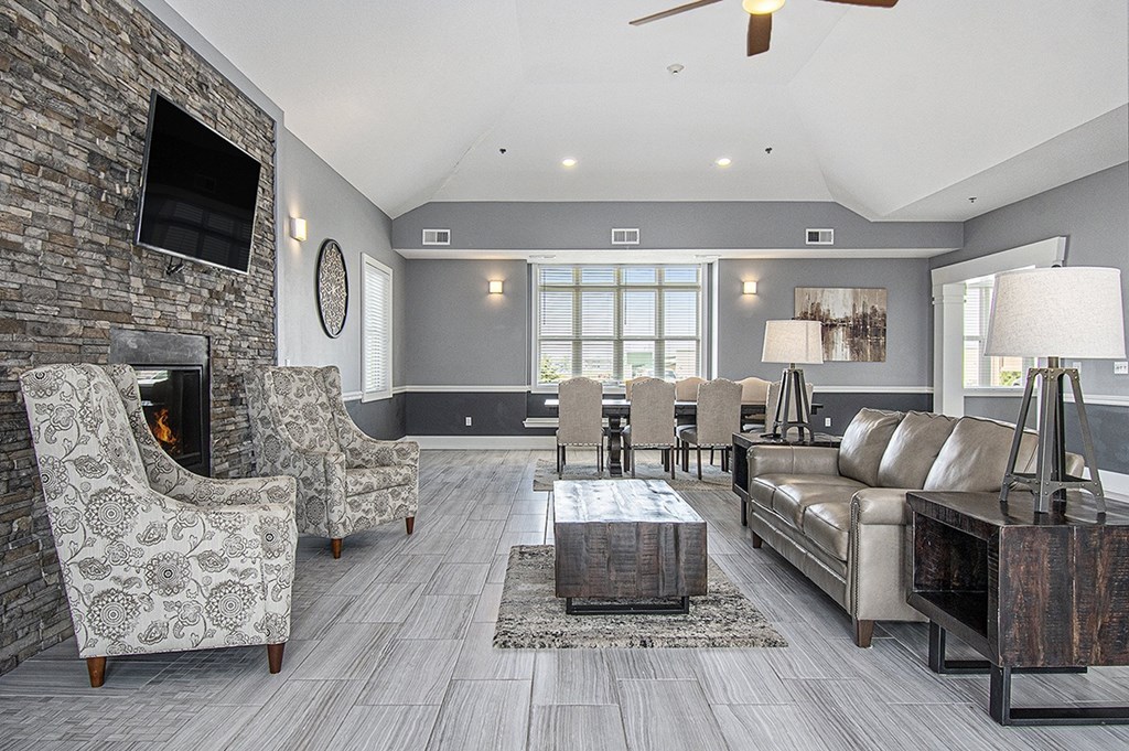 A community building with a fireplace and a television on the wall at The Reserve at The Reserve at Destination Pointe in Grimes, IA 50111