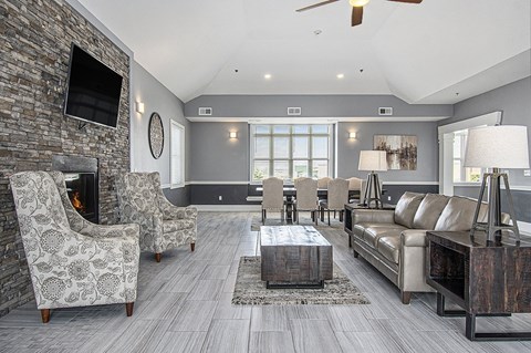 A community building with a fireplace and a television on the wall at The Reserve at The Reserve at Destination Pointe in Grimes, IA 50111