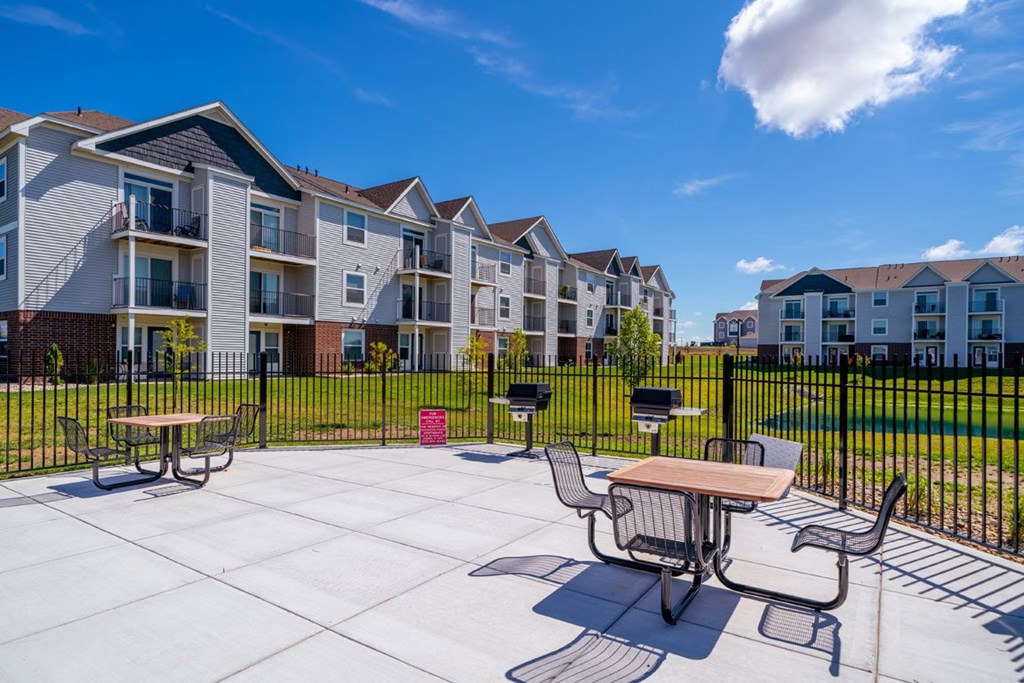 A sunny day at a grilling stations with seating area at The Reserve at Destination Pointe, Grimes, Iowa