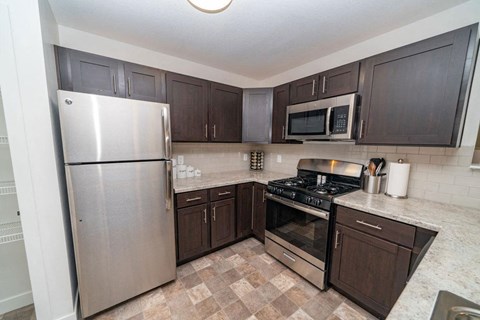 a kitchen with stainless steel appliances and wooden cabinets