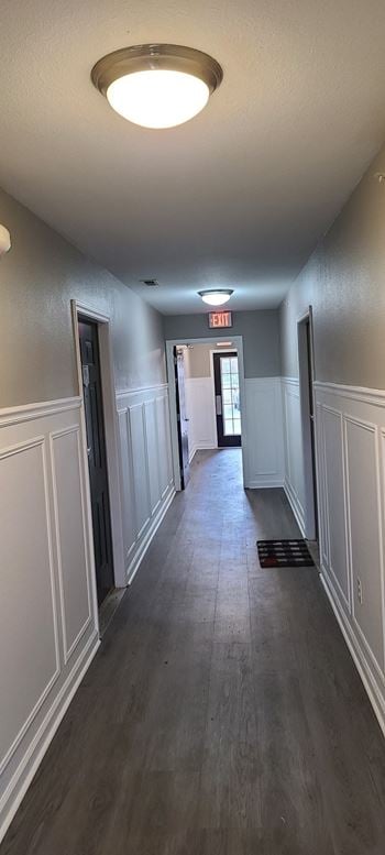 a long hallway with white walls and wood floors