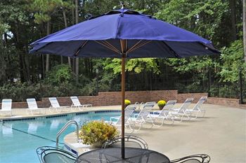 a blue umbrella sitting next to a swimming pool at Brook Pines, Columbia, SC
