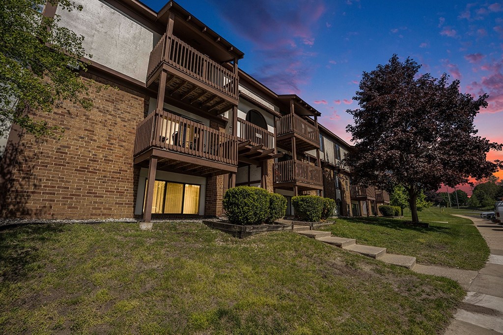 A building with balconies and a tree in front at Seville Apartments, Michigan
