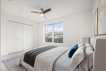 a bedroom with a large window and a ceiling fan at Stoney Pointe Apartment Homes, Wichita, 67226