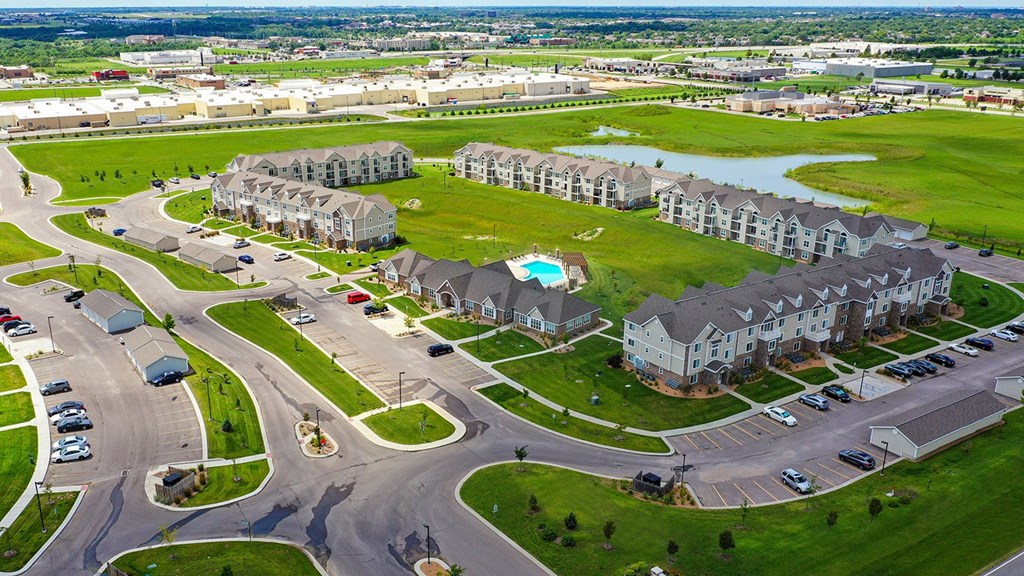 A drone view of an apartment community with a pool at Stoney Pointe Apartment Homes, Kansas, 67226