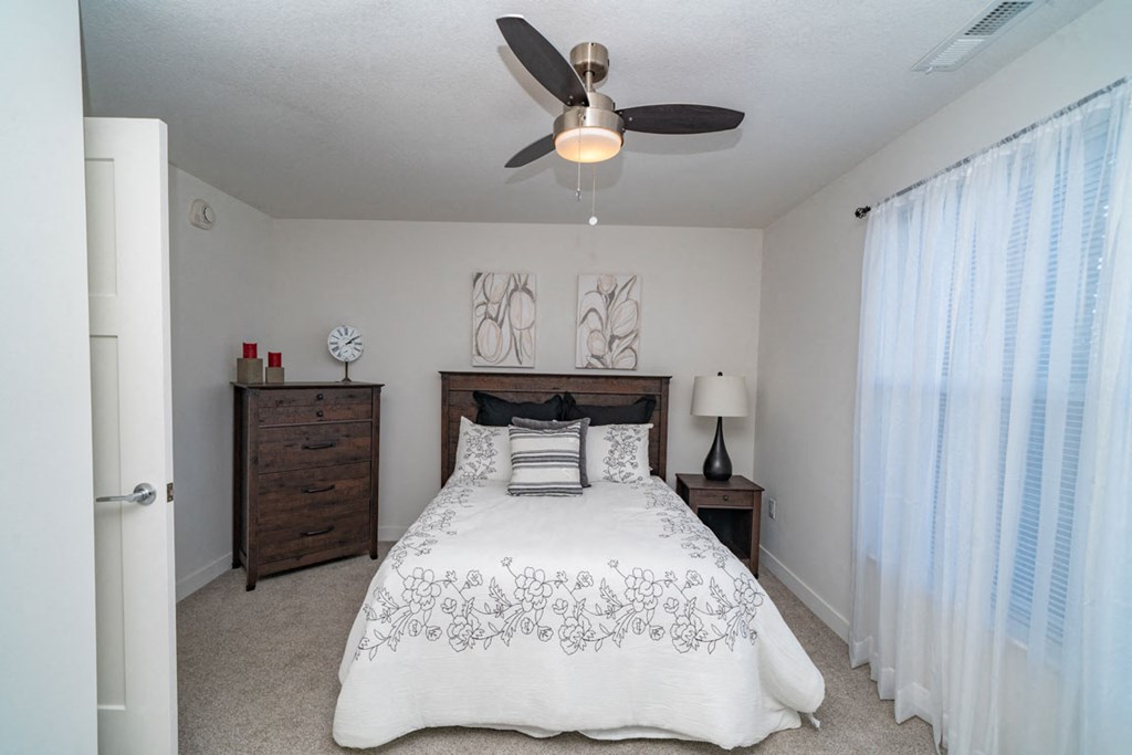 Master bedroom with a ceiling fan at Strathmore Apartment Homes, Iowa