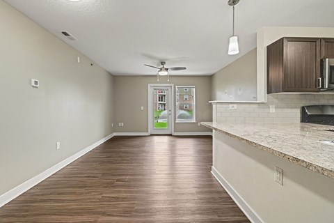 A kitchen area with a refrigerator, microwave, and oven.