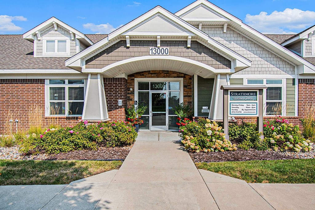 The front of a brick leasing office/community building/fitness center at Strathmore Apartment Homes, West Des Moines, IA