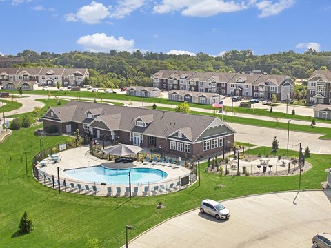 A large building with a pool in front of it.