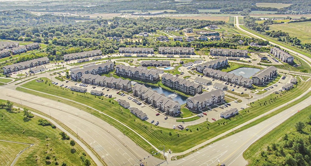 A bird's eye view of an an apartment community with ponds at Strathmore Apartment Homes, West Des Moines, IA