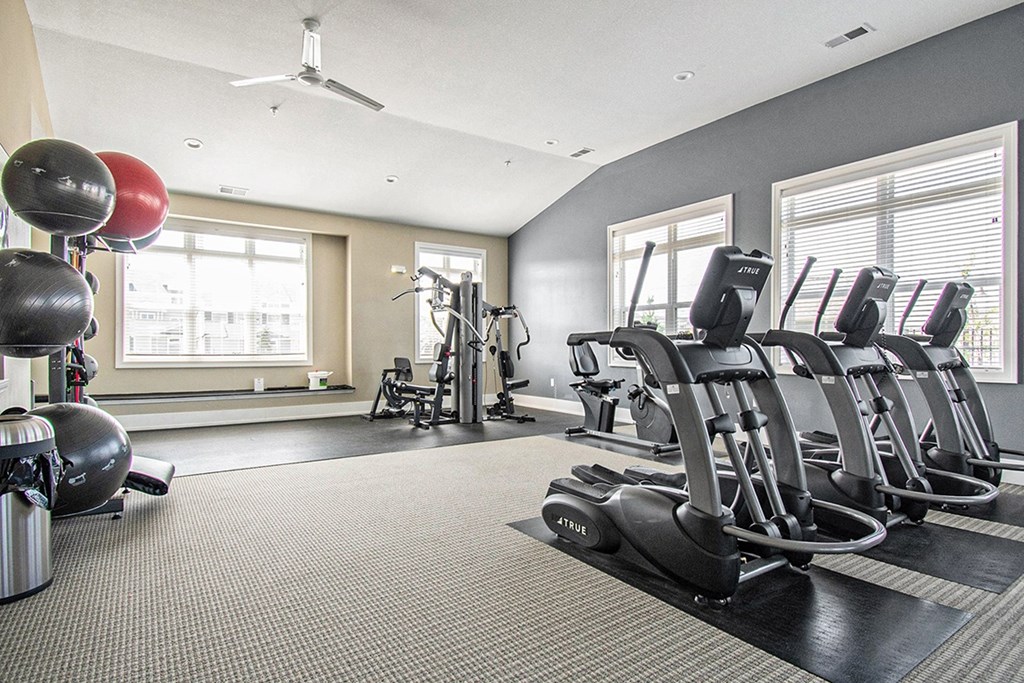 Cardio machines in fitness center at Strathmore Apartment Homes, Iowa