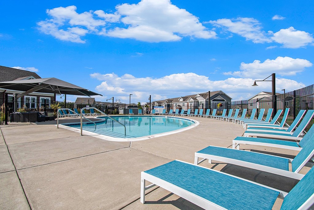 Swimming pool with lounge chairs at Strathmore Apartment Homes in West Des Moines, Iowa