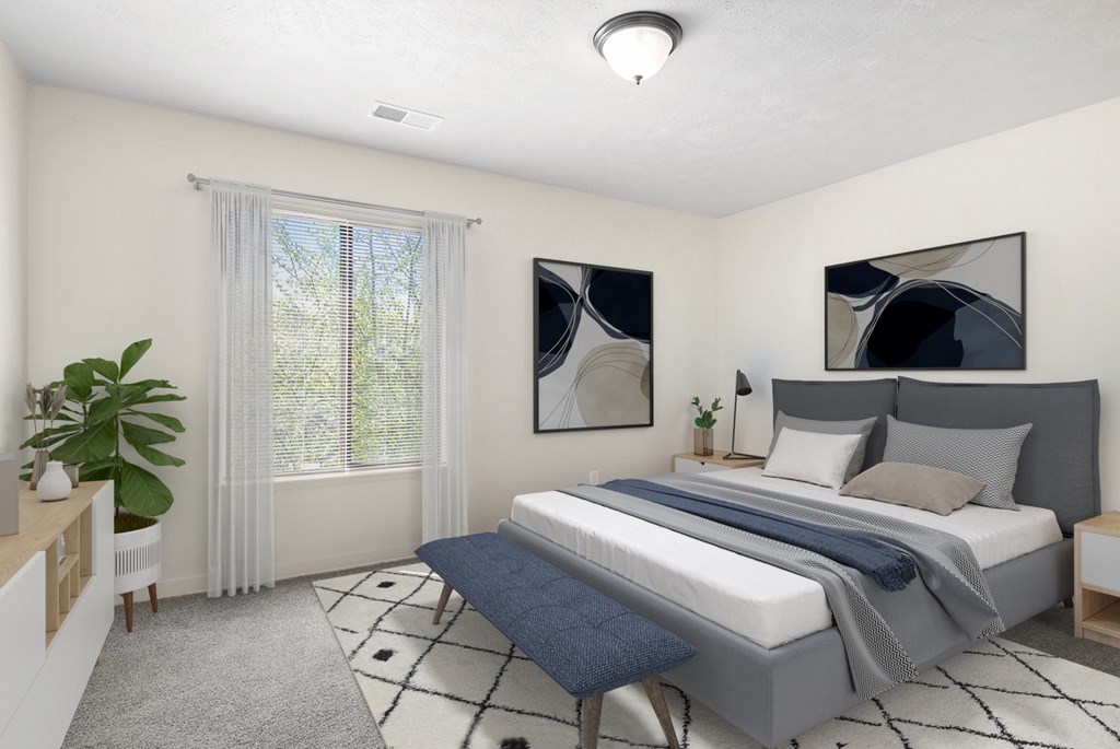 A bedroom with a large bed and a window with blinds at Swiss Valley Apartments in Wyoming, MI