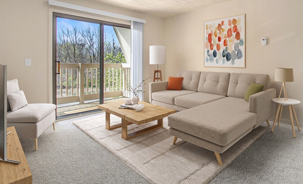 A living room with a couch and a slider to a private balcony at Swiss Valley Apartments, Wyoming, MI