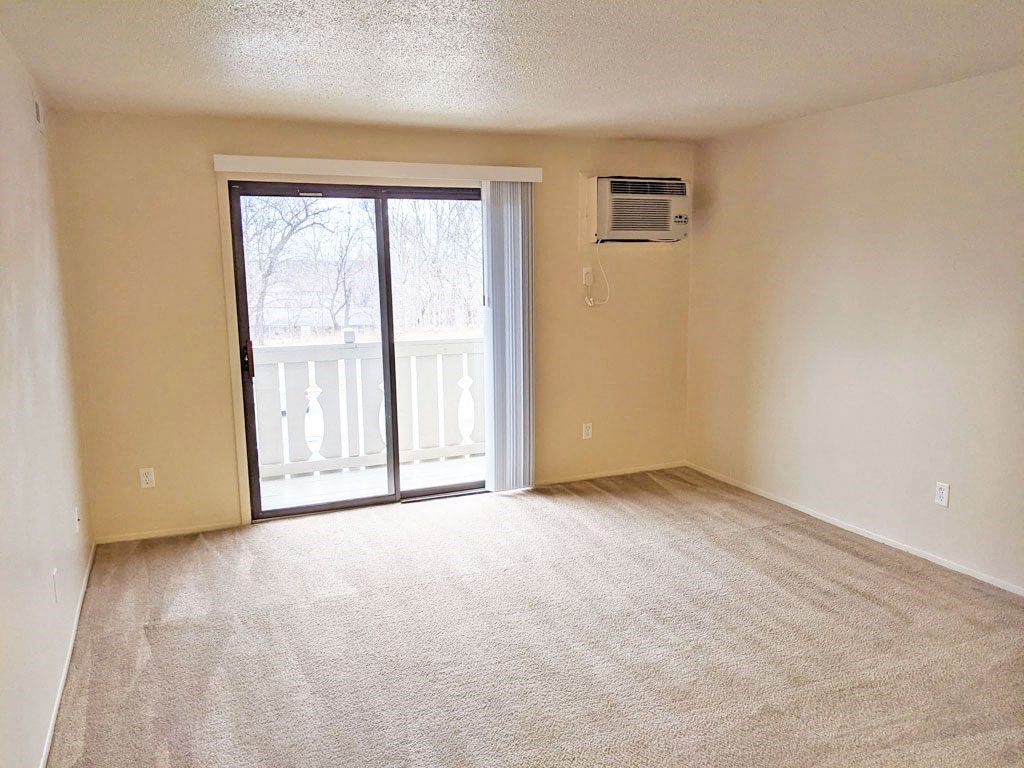 Living Room with Balcony Access at Swiss Valley Apartments, Wyoming, MI