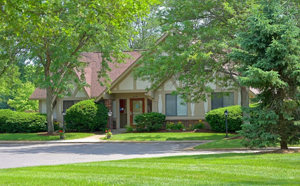 a house with a driveway and trees in front of it  at Sycamore Creek Apartments, Lake Orion, 48359