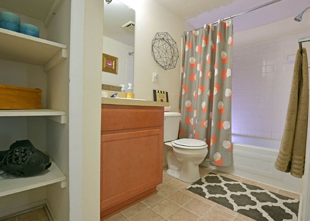 a bathroom with a shower toilet and sink at Sycamore Creek Apartments, Lake Orion, Michigan