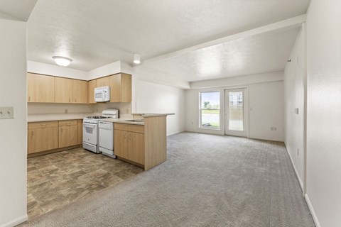 A kitchen with wooden cabinets and a white dishwasher.