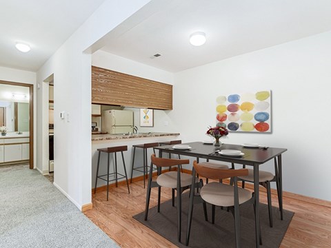 A modern kitchen with a dining table and chairs.