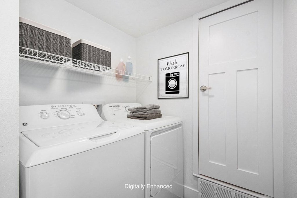 a laundry room with a washer and dryer at The Crossings Apartments, Michigan, 49508