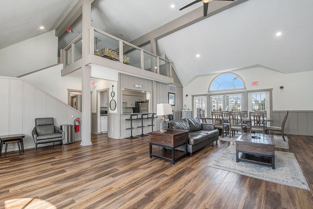 A community room with vinyl plank flooring and large windows at The Crossings Apartments in Grand Rapids, MI