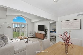 a living room with a cathedral ceiling at Tracy Creek Apartment Homes in Perrysburg, OH